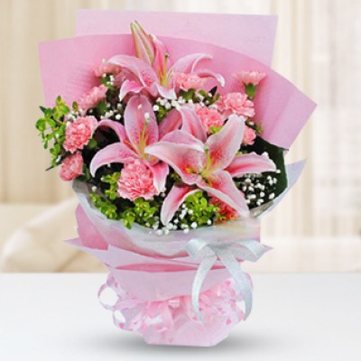 Bunch of 2 pink lilies, 10 pink carnations, baby's breath and foliage. Radiant Pink