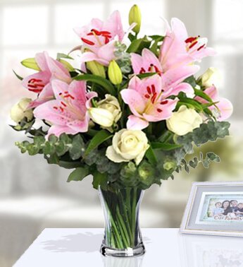 10 Stem of White Roses and 3 Stem of Pink Lilies with fillers in a Glass Vase. (one sided round arrangement) Cheery Bouquet