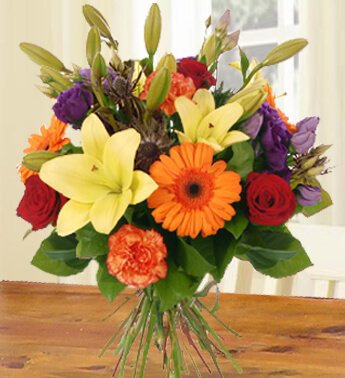 Bunch of 4 Stems Of Yellow Lilies ,3 Stems Of Red Roses ,3 Stems Of Peach Carnations & 3 Stems Of Orange Gerberas with fillers in nice wrapping All For You