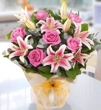 Bunch of 3 Stems of Pink Lily & 8 Stems of Pink Rose in nice wrapping Blush Of Love