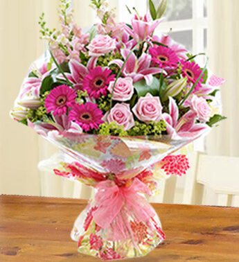 Bunch of 4 stems of Dark Pink Gerbera, 3 stems of Pink Lily and 5 stems of Pink Rose in nice wrapping Exotic Lilies