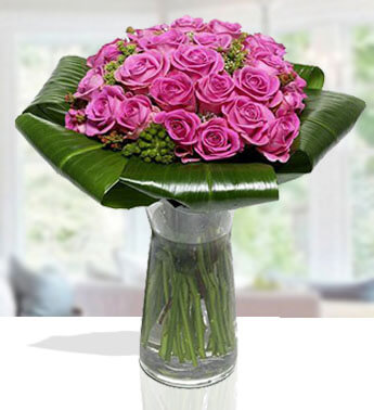 24 Purple Roses with leaves in a glass vase. Lavender Roses