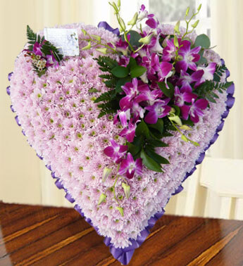 Heart shape arrangement of 16 stems of Pink Chrysanthemums and 10 Purple orchids. Pink Heart