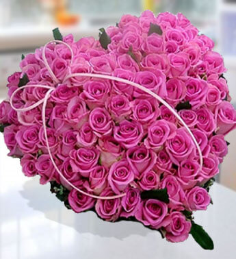 Heart shape arrangement of 60 stems of Pink Roses with greens. Romantic Pink Heart