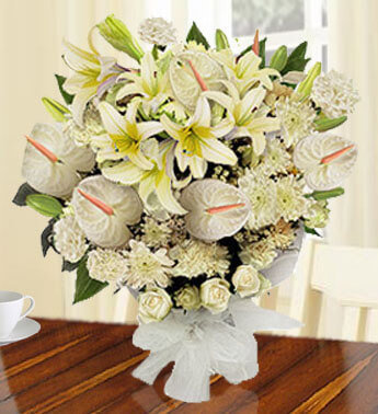 Bunch of 5 stems of White Lilies, 5 stems of White Anthuriums,10 stems of White Carnations,10 Stem of White Roses & 2 stems of White Chrysanthemums with fillers in a nice wrapping paper. Moon Light