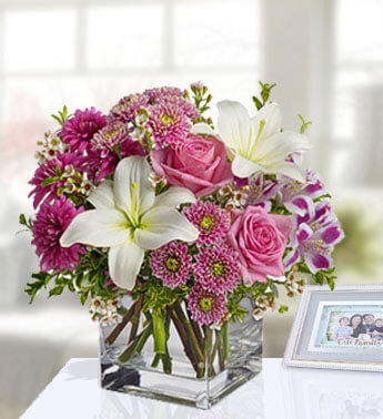 3 stems of Pink Rose, 4 stems of Pink Chrysanthemum and 1 White Lilies in a cube vase. (one sided round arrangement) You're special