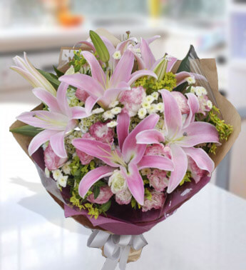 Bunch of 3 stems of Pink Lilies, 8 White Rose, 3 stems of white and 2 stems of Pink Chrysanthemums in a nice wrapping. Feminine Gift